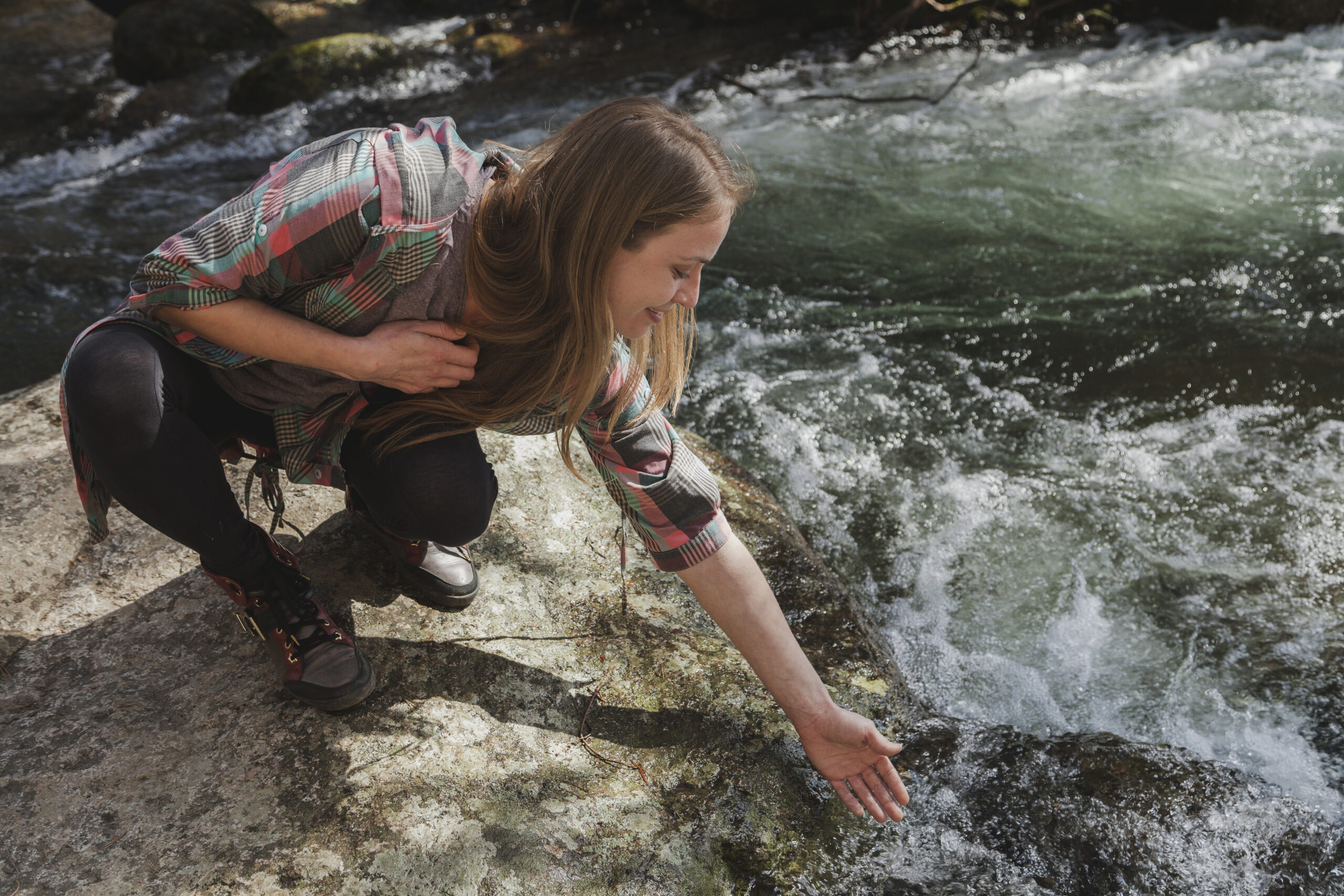 close-up-young-woman-wetting-her-hand-river